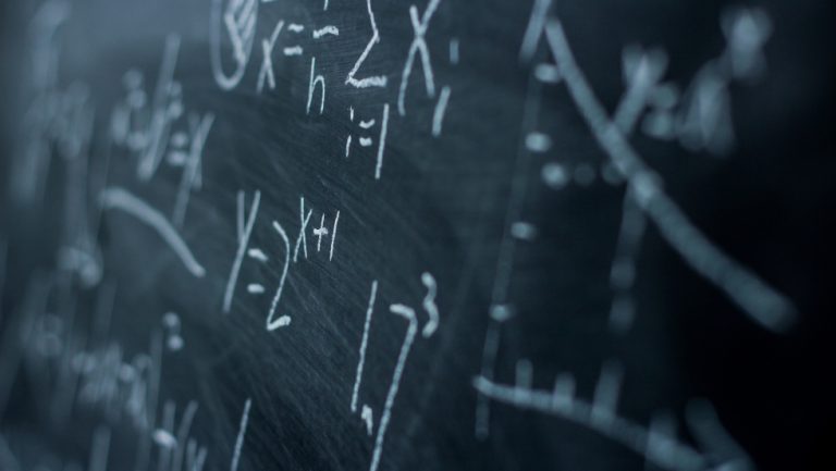 Maths formulas on chalkboard background